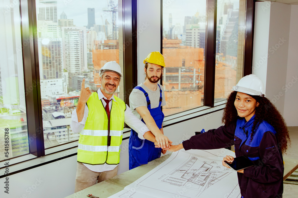 Team of senior architects and female architect assistants and male