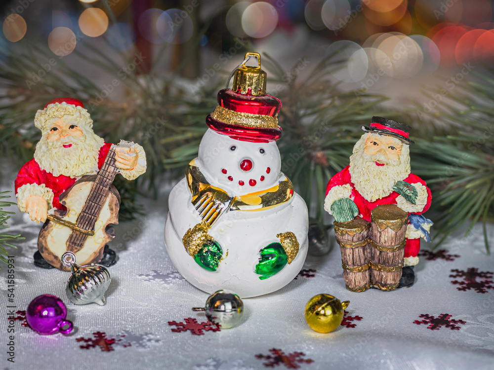 Santa and snowmen ornaments placed on decorative table against beautiful boke
