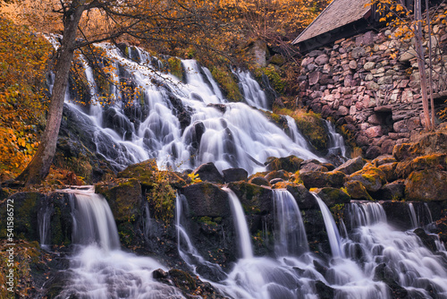 Beautiful waterfall in autumn forest in Jonkoping, Sweden. Long exposure.