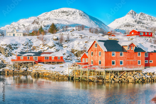 Outstanding morning seascape of Norwegian sea and cityscape of Sorvagen town.