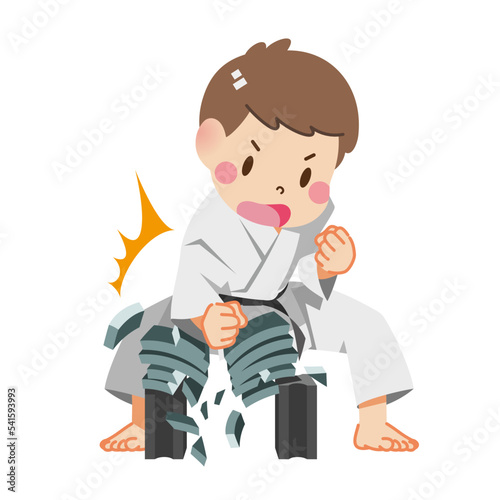 Boy breaking tiles with karate