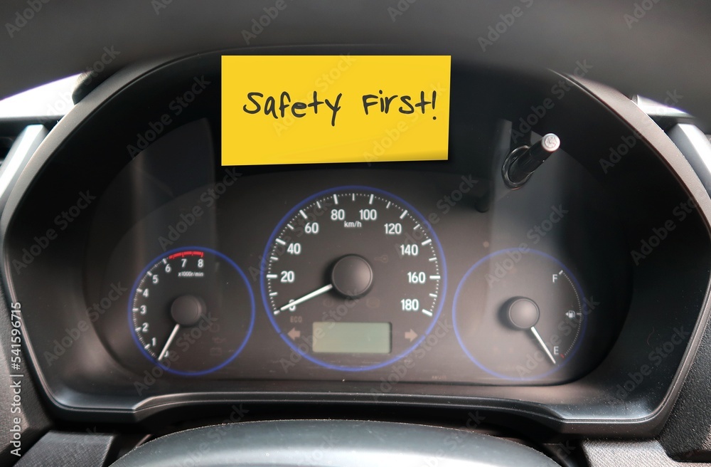 Car console panel with handwritten stick note SAFETY FIRST , concept of car driver self reminder to to drive carefully with mindset of safety first, be alert to reduce accidents on the road