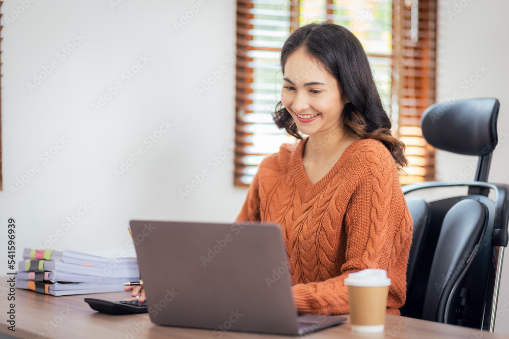 Freelancer Asian businesswoman Accounting work at home using calculating income-expenditure and analyzing real estate investment data report Financial and Documents tax systems concept. Freelancer Asian businesswoman Accounting work at home using calculating income-expenditure and analyzing real estate investment data report Financial and Documents tax systems concept.