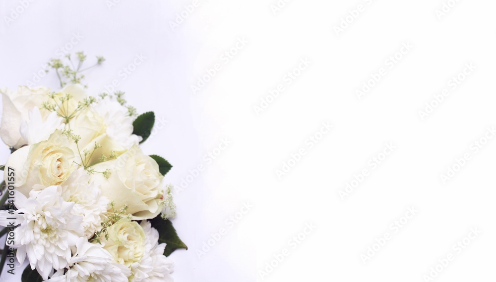 White roses and white chrysanthemums on a white background. Festive flower arrangement. Background for a greeting card.