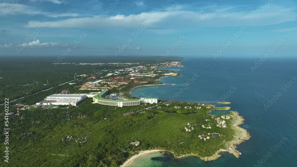 Aerial view overlooking resorts on the coast of sunny Xpu-Ha, Mexico - reverse, drone shot Aerial view overlooking resorts on the coast of sunny Xpu-Ha, Mexico - reverse, drone shot