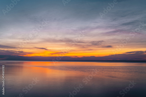 The dramatic sky during colorful red and purple sunset over the ocean on the outer banks of Long Island New York. High-quality photo