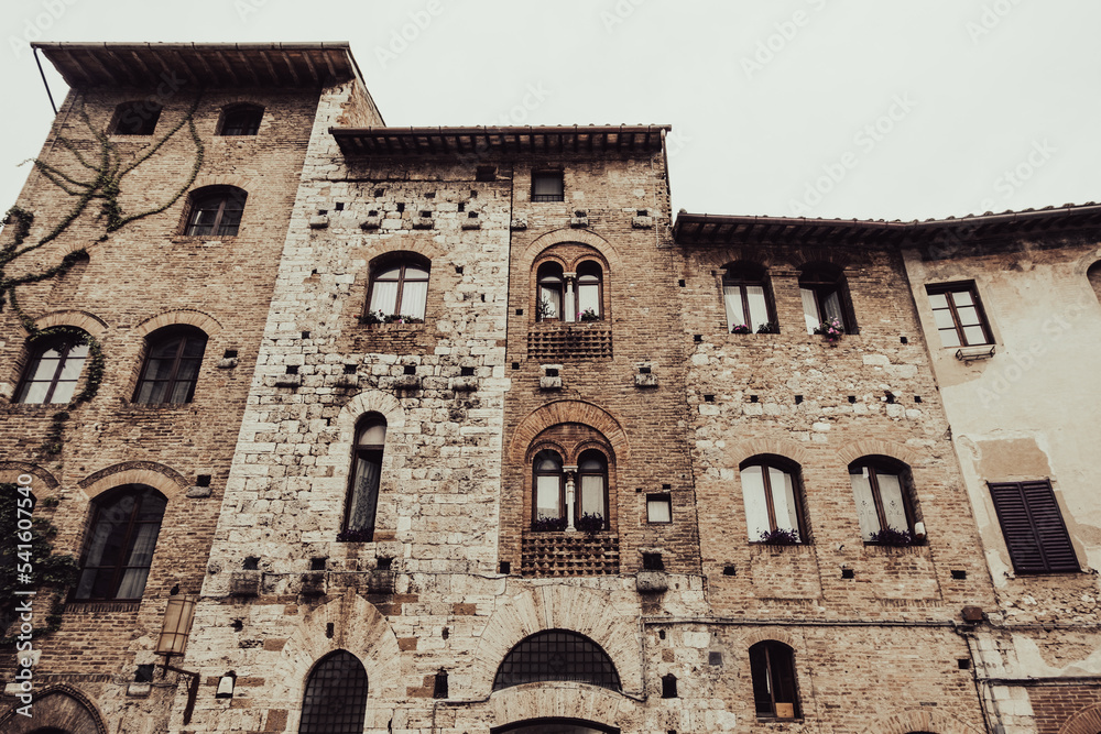 Front facade of aged medieval buildings of San Gimignano