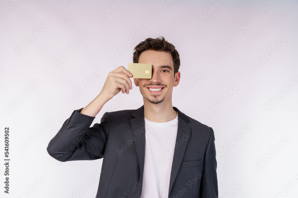 Portrait of Young smiling handsome businessman showing credit card isolated over white background Portrait of Young smiling handsome businessman showing credit card isolated over white background