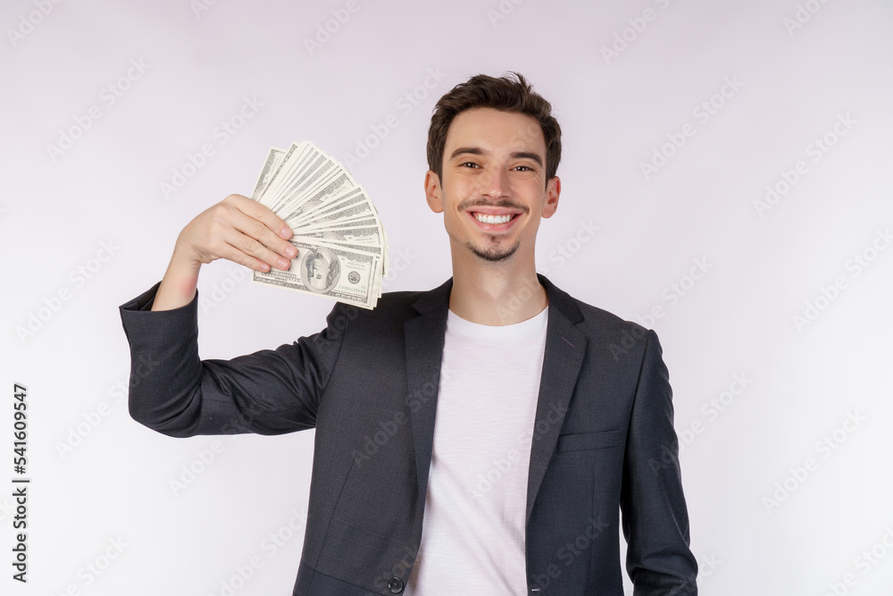 Portrait of a cheerful man holding dollar bills over white background Portrait of a cheerful man holding dollar bills over white background
