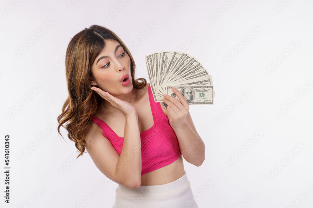 Portrait of excited young woman holding bunch of dollars banknotes isolated over white background Portrait of excited young woman holding bunch of dollars banknotes isolated over white background