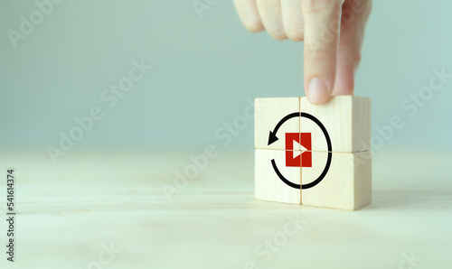 Replay icon on wooden cubes on smart grey background and copy space. Recap business, meeting summary, business review concept.