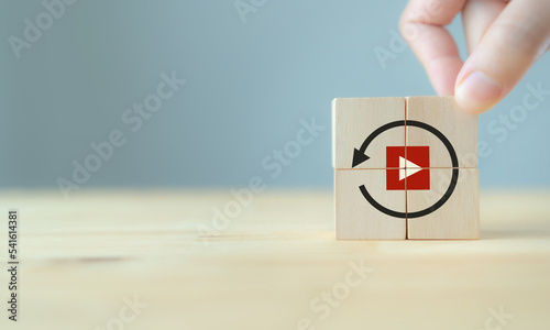 Replay icon on wooden cubes on smart grey background and copy space. Recap business, meeting summary, business review concept.