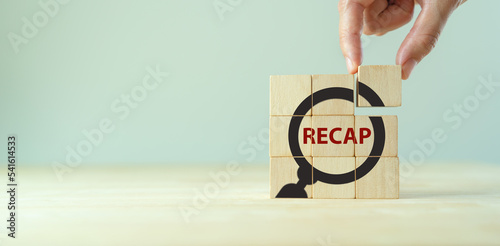 Recap economy, business, financial concept. Business plan in 2023.  RECAP words and magnifying glass icon on wooden cubes on smart grey background and copy space.