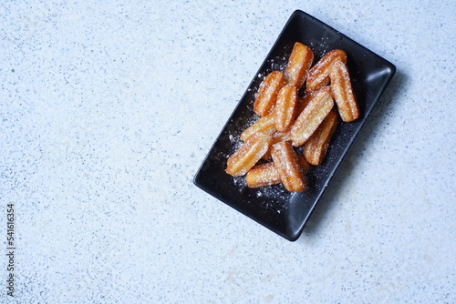 a plate of churros in white background 