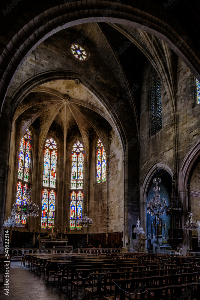 Interior, cross ribbed vault and stained glass of the gothic Saint Etienne collegiate church of Capestang, in the South of France (Herault)