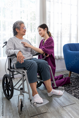 Caregiver nurse take care a Senior patient sit on wheelchair. Nurse helping senior Woman © kanpisut