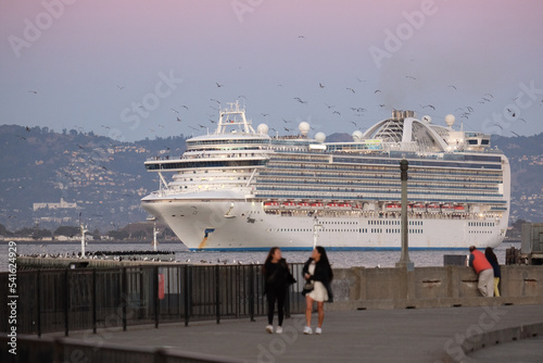 Princess cruiseship or cruise ship liner Ruby P in San Francisco port Bay terminal sail away cruising with downtown skyline twilight blue hour sunset sky Alcatraz Golden Gate sailing boats yachts photo