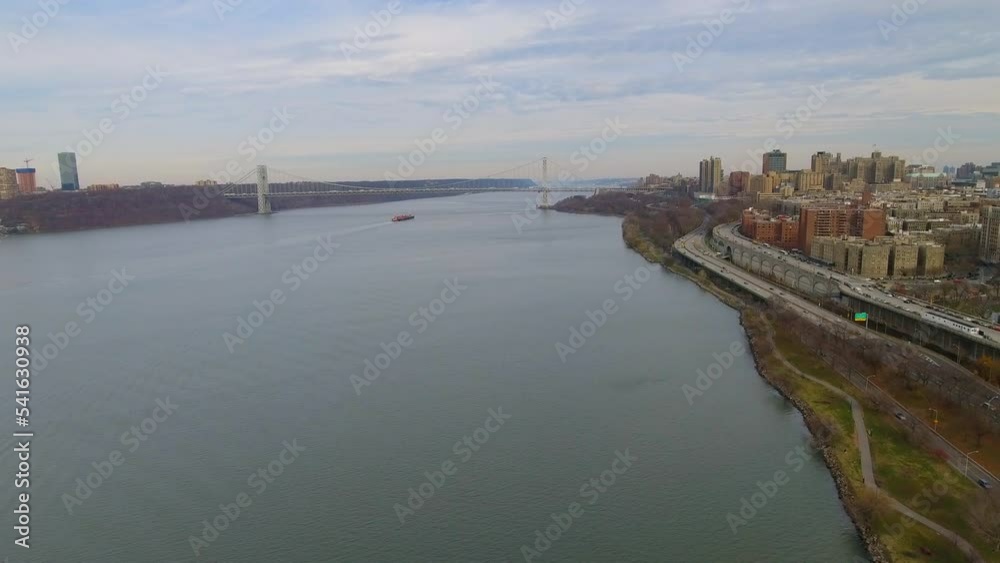 Aerial Shot Of Famous Suspension Bridge In Residential City, Drone Flying Backwards Over East River - New York, New York Aerial Shot Of Famous Suspension Bridge In Residential City, Drone Flying Backwards Over East River - New York, New York