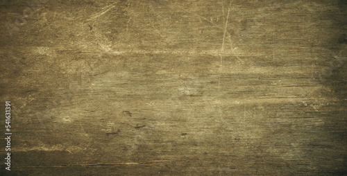 Photo of the worn texture of an old tree. Vintage wooden background with rapids for text. Old wood texture on the table.
