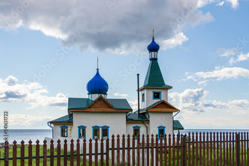 Church on the shore of Lake Baikal. The Church of St. Nicholas is a landmark of the village of Bolshoe Goloustnoe. photo