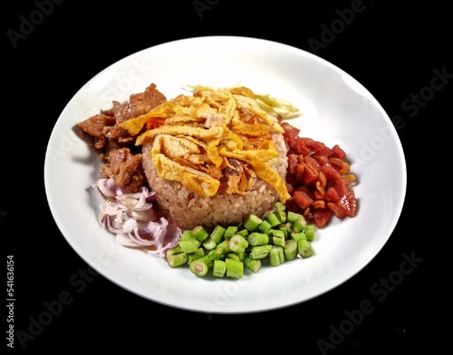 "Khao Kluk Kapi", a traditional Thai dish with a mixture of various seasonings such as rice, shrimp paste, shallots, shrimp, pork, mango, egg, and chili. It is a delicious recipe. and good for health