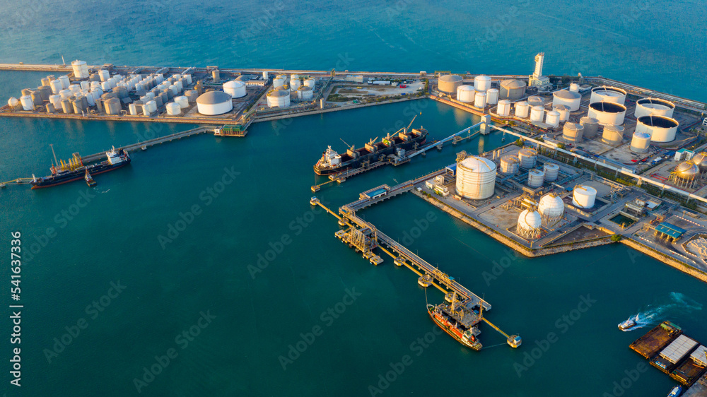 Oil refinery or petroleum refinery in the industrial factory of heavy industry, oil production plant. Crude oil tanker and Gas tanker container ship, coal powered electricity plant