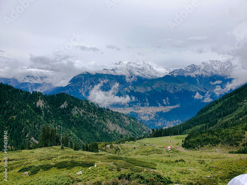 A selective focus on Mountains at Blur View of Clouds at top of The Desan Meadows Mountain Kalam Valley