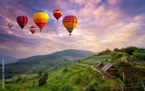 Colorful hot air balloons flying over mountain in sunrise at Khun Pae, Chiang Mai, Thailand. © somchairakin