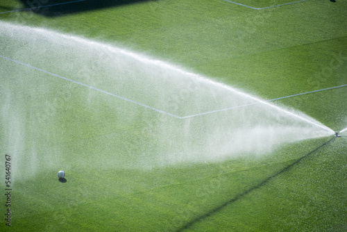 Overhead view of sprinklers watering a football pitch, Spain