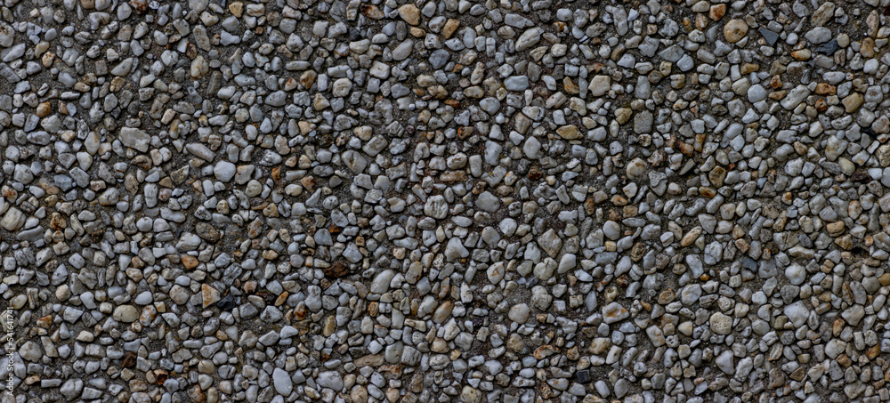 Panorama of small pebbles in concrete wall for background Panorama of small pebbles in concrete wall for background