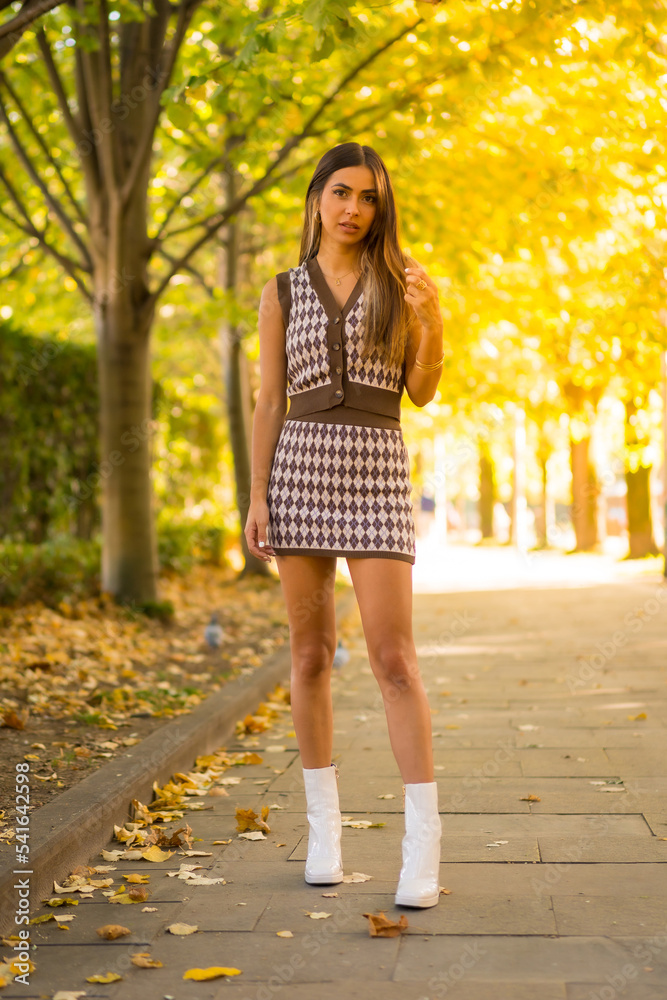 Portrait of a caucasian brunette woman in autumn, walking through a natural park in the city, autumnal lifestyle Portrait of a caucasian brunette woman in autumn, walking through a natural park in the city, autumnal lifestyle