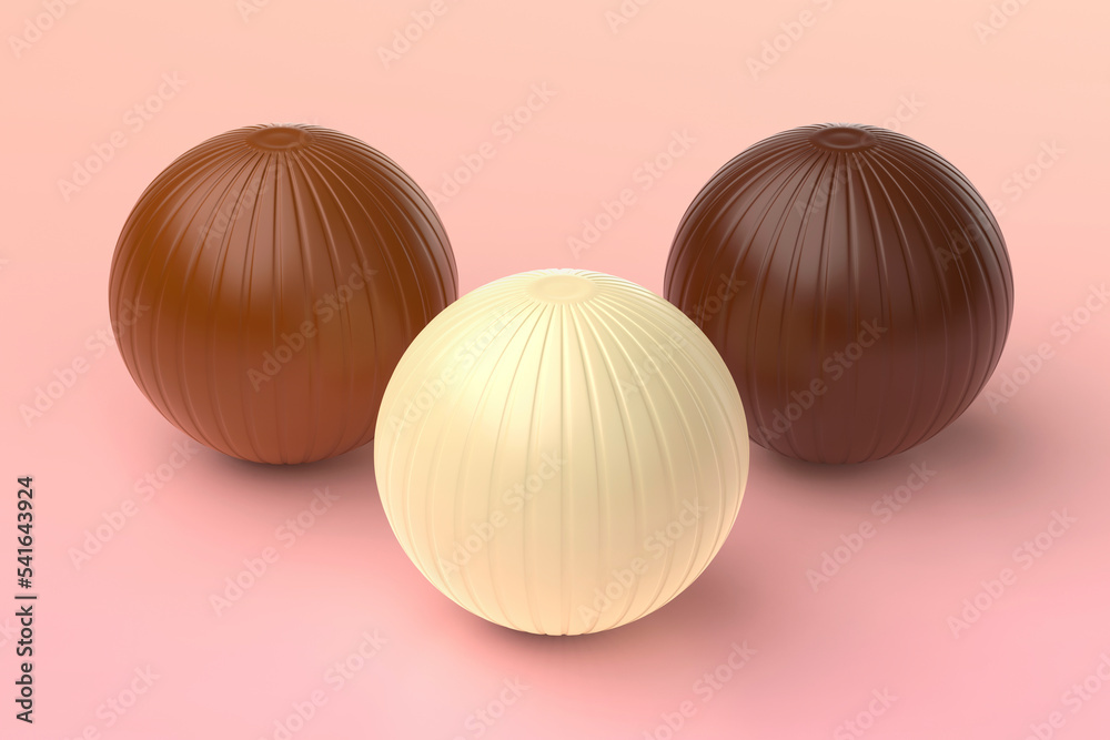 White, milk and dark chocolate balls on pink background White, milk and dark chocolate balls on pink background
