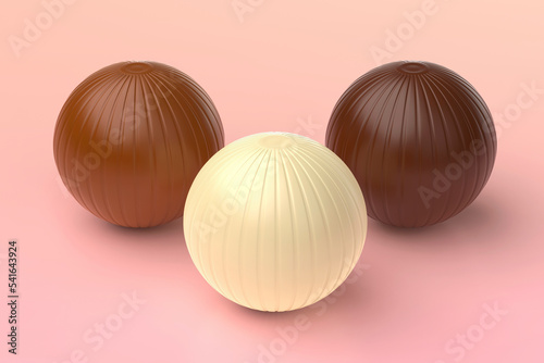 White, milk and dark chocolate balls on pink background