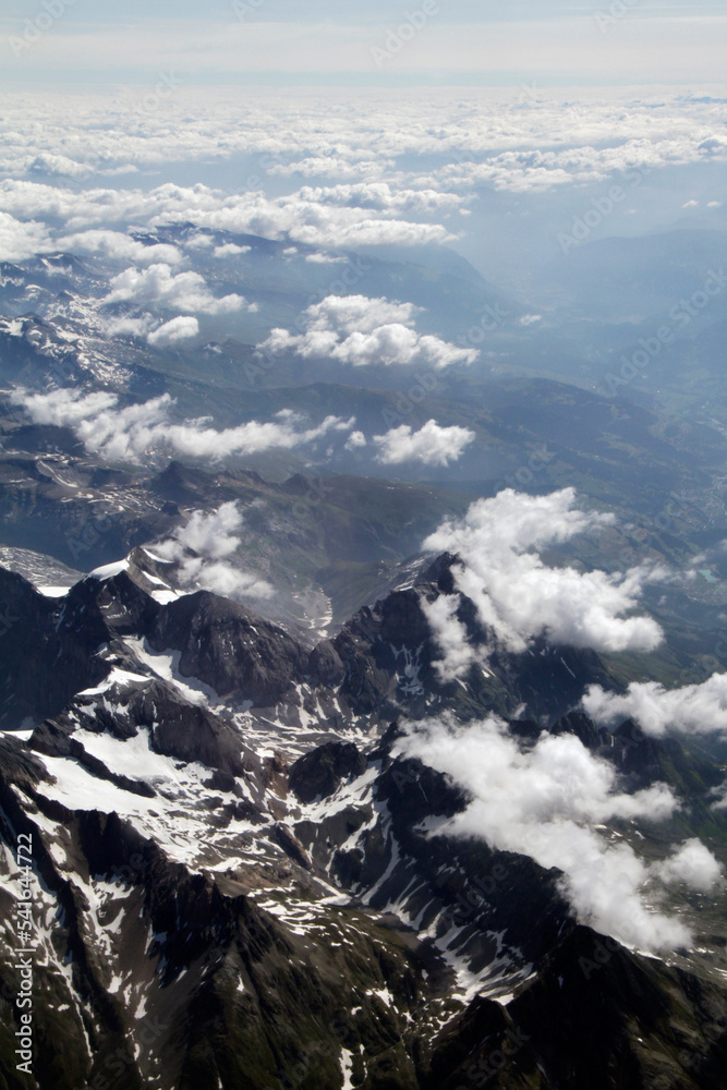Snow covered mountain seen from a plane over the European Alps