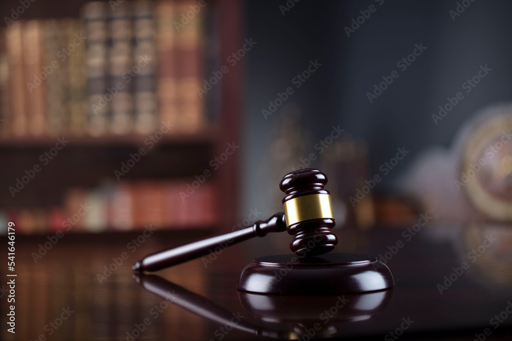 Lawyer office. Judge’s gavel, scale, Themis sculpture and legal books in the bookshelf. Lawyer office. Judge’s gavel, scale, Themis sculpture and legal books in the bookshelf.