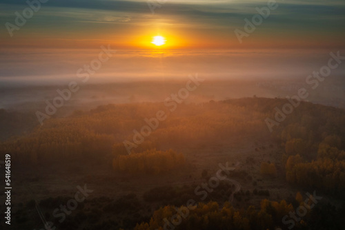 Beautiful landscape with morning fog over the forest in Poland photo