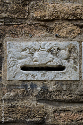 Una tipica buca per le lettere a forma di volto sul muro di una casa di Venezia  photo
