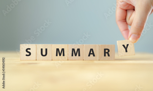 Summary text on wooden cube blocks. Past performance analysis for learning and improvement. Preparation for business plan and strategy development. Meeting, working, project summary report.