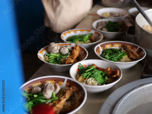 Selective focus Mie ayam, mi ayam or bakmi ayam indonesian for chicken bakmi, literally chicken noodles, is a common Indonesian dish of seasoned yellow wheat noodles topped with diced chicken meat. photo