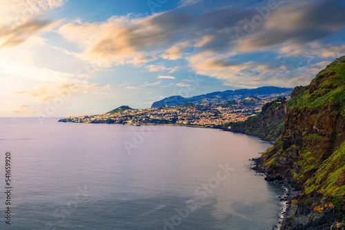 Sunset over the city of Funchal and cliffs of Madeira Island