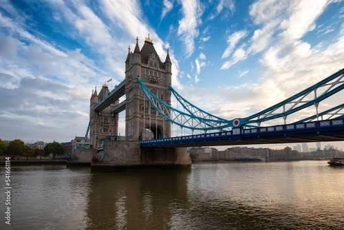 Historic Bridge over River Thames and Cityscape Skyline during dramatic sunrise. Tower Bridge in City of London, United Kingdom. Travel Destination.