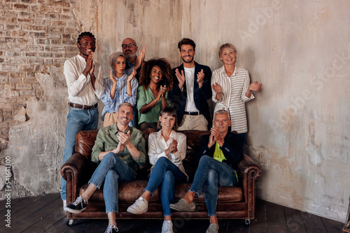group photo of smiling business creative workers colleagues after teambuilding clapping for target success photo
