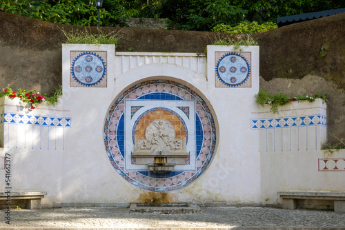 Narrow streets of Sintra village with ancient azulejo fountain