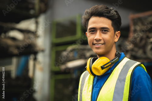 portrait young male worker engineer working in heavy industry with safety happy smile looking camera