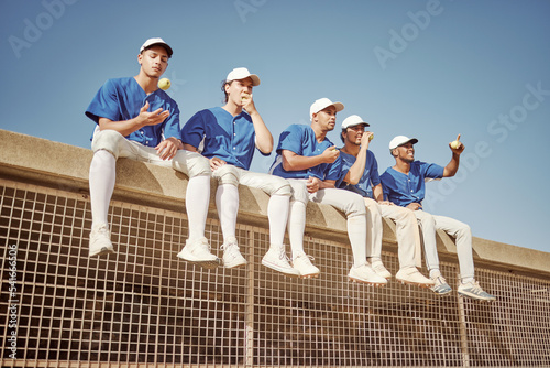 Photography Sports, baseball and team of men together smiling and happy sitting in row eating apple
