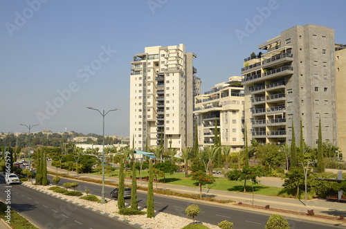 Beautiful residential building. Modern housing. Israel - high-rise building, flowering and palm trees. Concept: nice place to live, real estate purchase 