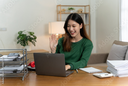 Asian girl with laptop computer on desk. © PaeGAG