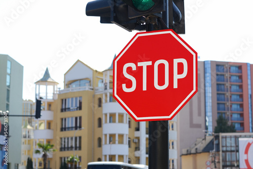 Post with sign Stop near traffic lights outdoors, space for text