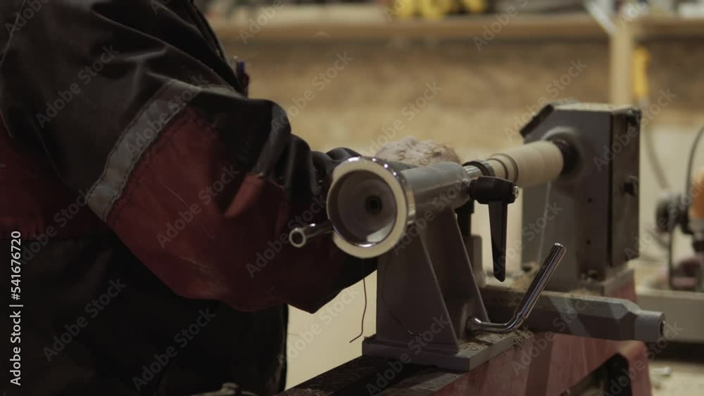 The carpenter with the help of a tool gives shape to wooden blanks on a machine. 4k. dust and shavings fly to the sides. close-up. wood work. joinery The carpenter with the help of a tool gives shape to wooden blanks on a machine. 4k. dust and shavings fly to the sides. close-up. wood work. joinery