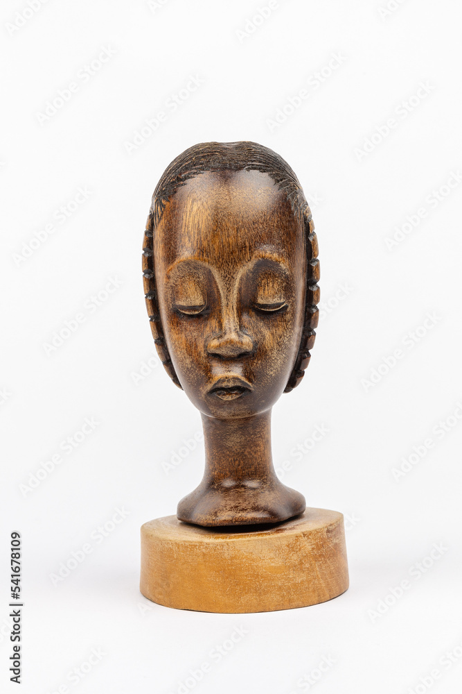 Wooden figurine of an African woman isolated on white background, front view Wooden figurine of an African woman isolated on white background, front view